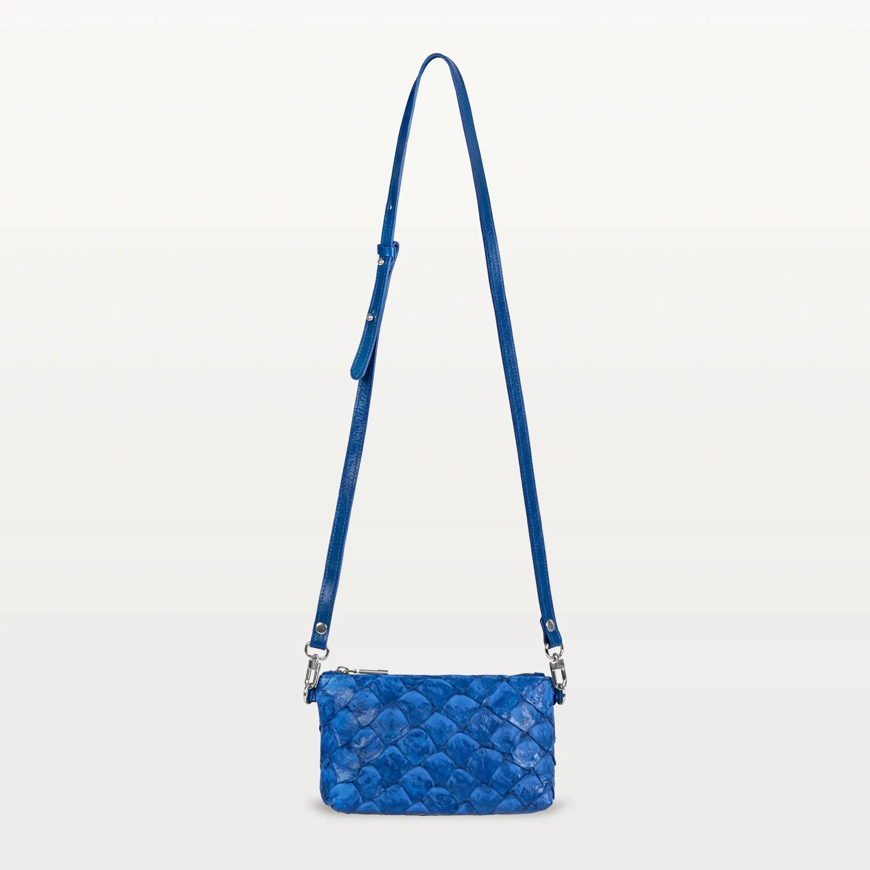 Small rectangular cobalt blue crossbody bag made of textured sustainable Pirarucu fish leather with long crossbody strap