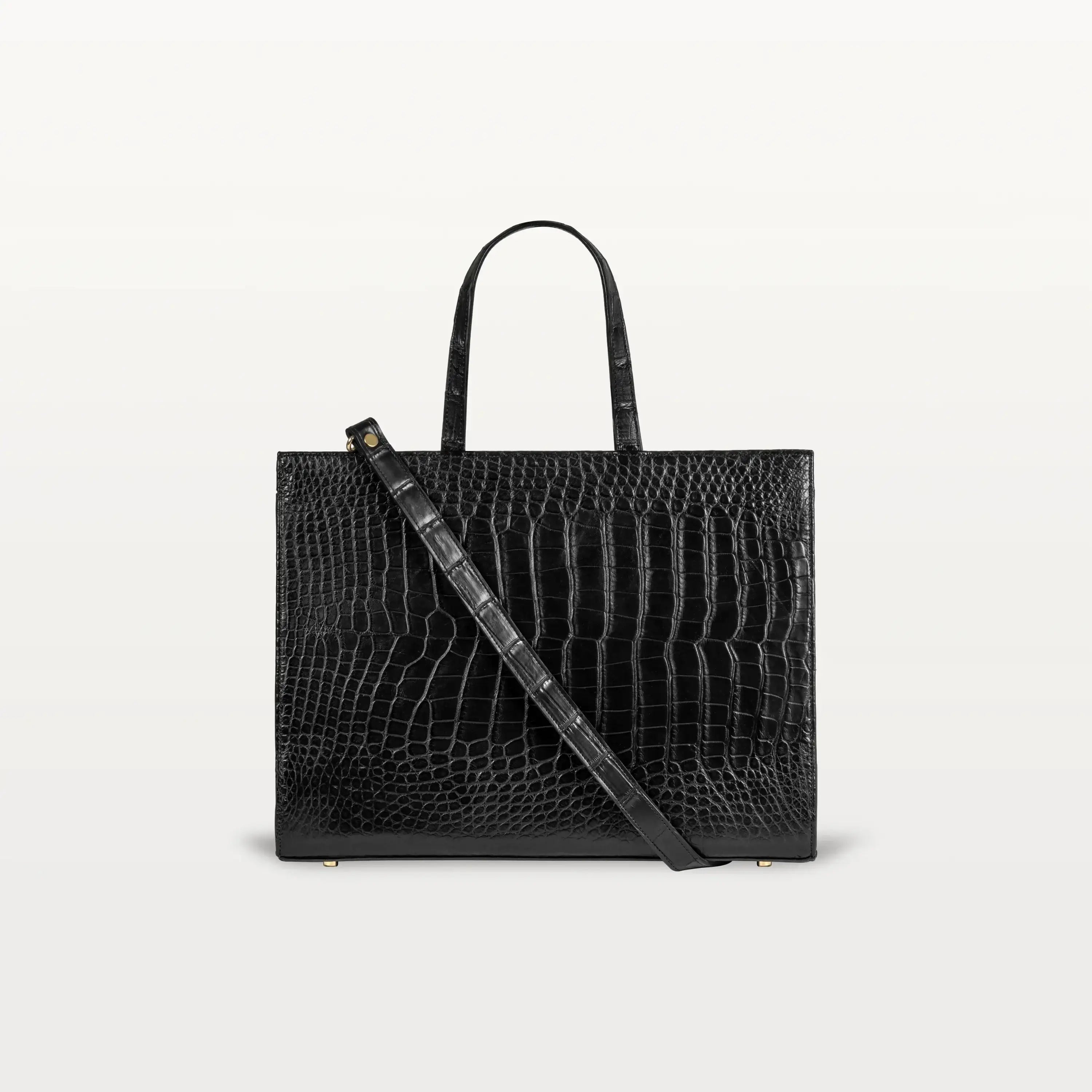 The Braemar tote bag in black alligator leather. A large, structured bag with top handles and crossbody strap.