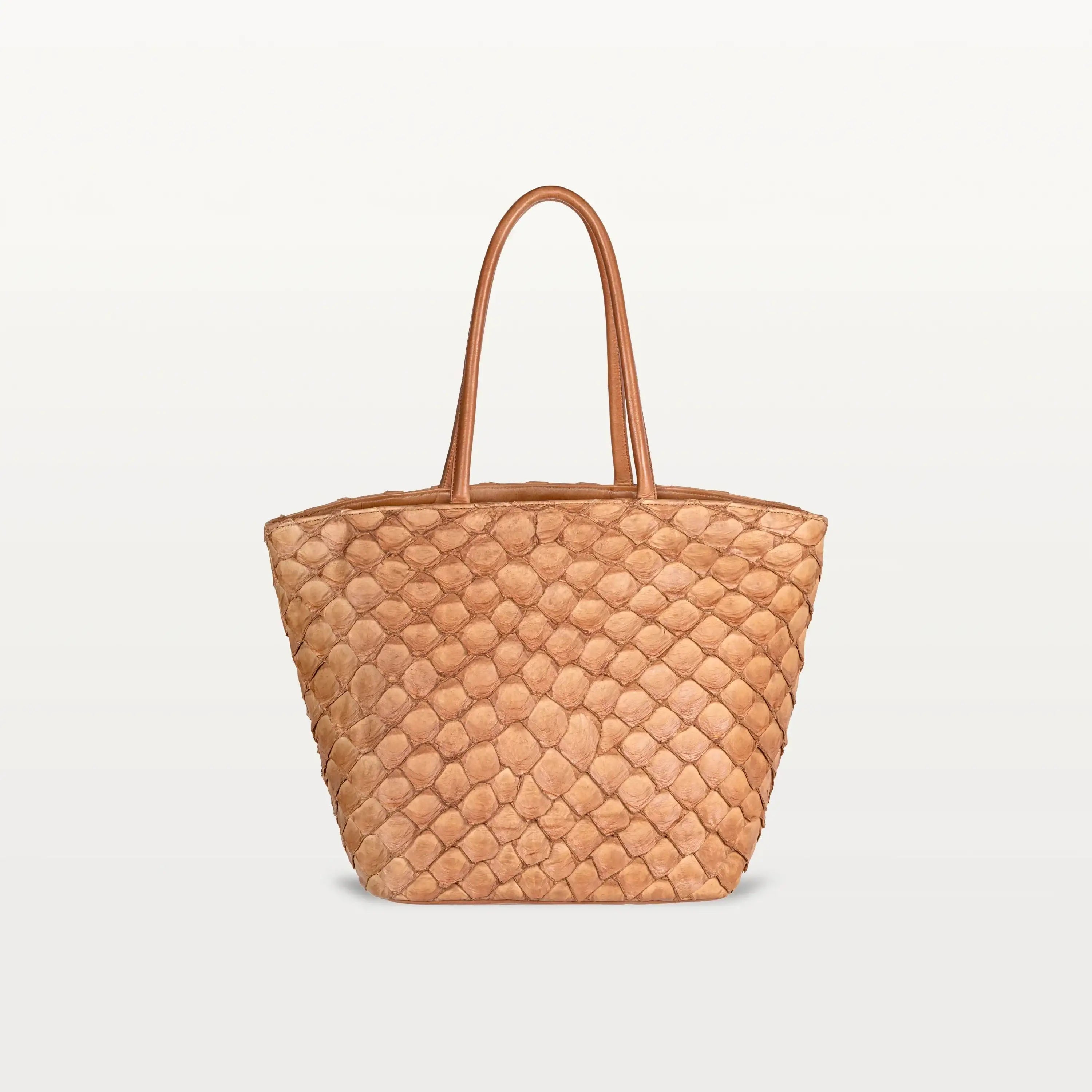 The Delray Shopper in cognac pirarucu leather, a large tote bag with a unique fish scale texture and two top handles.