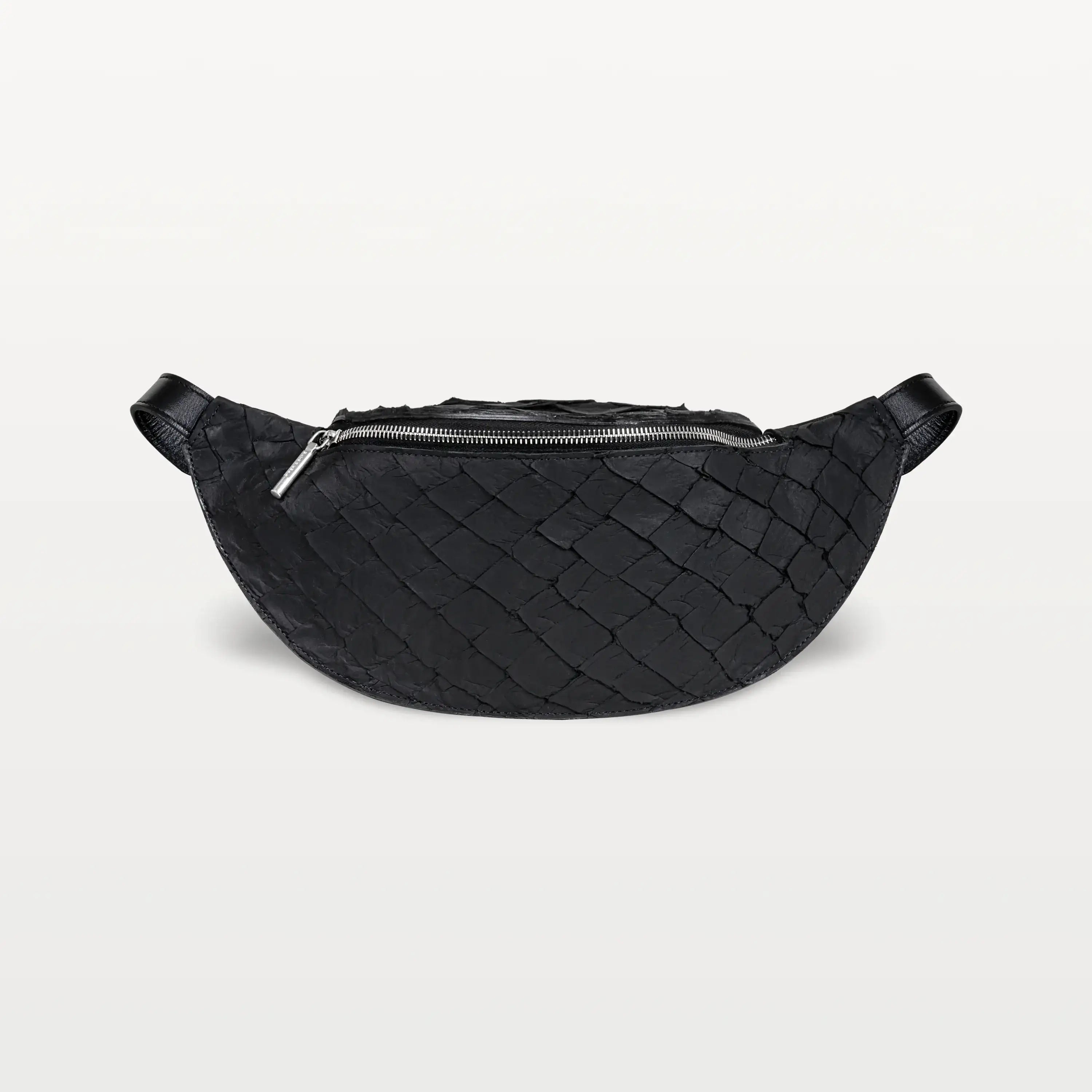 Front view of the Mac Pack belt bag crossbody in black Pirarucu fish leather with a silver zipper and curved body shape.