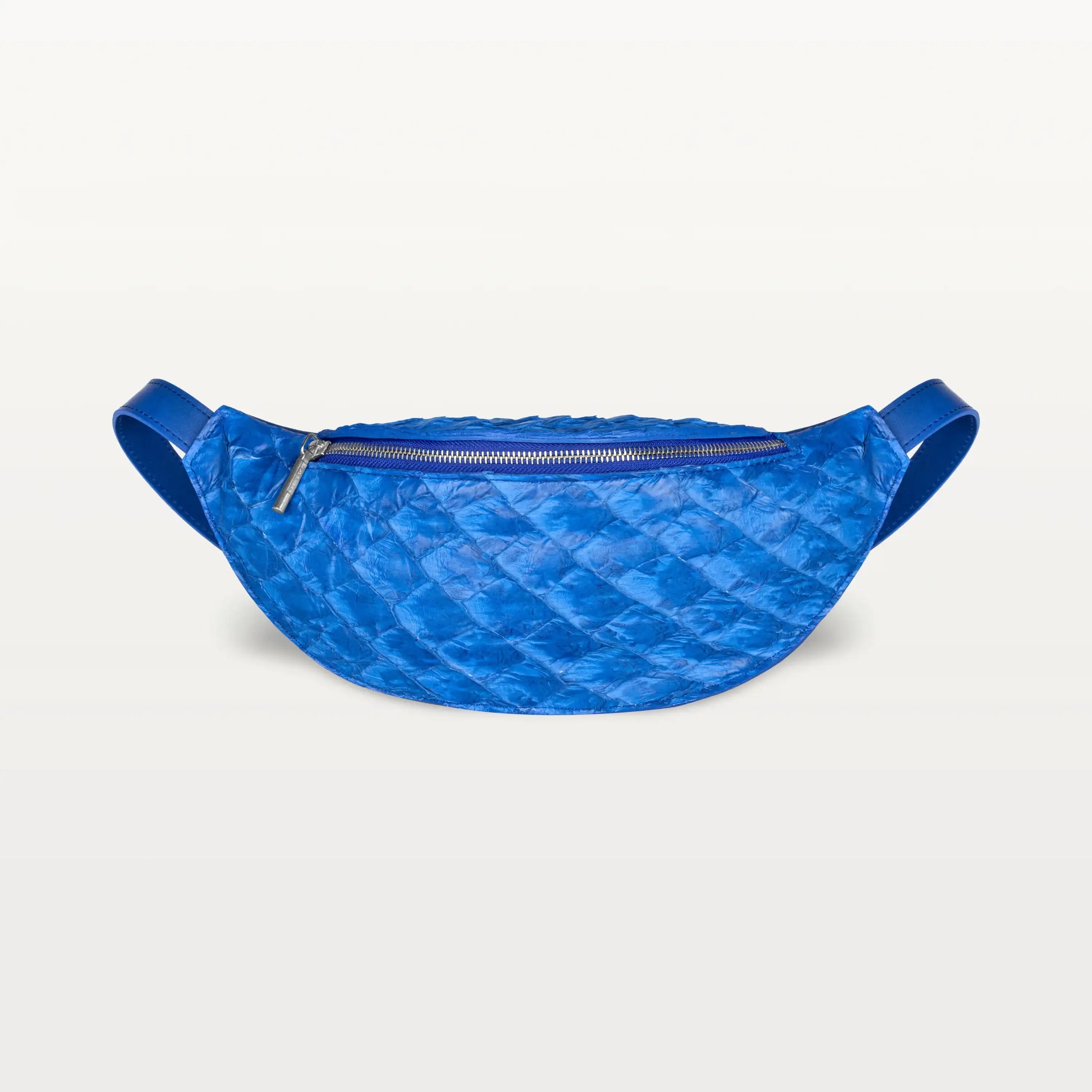 Front view of the Mac Pack belt bag in cobalt blue Pirarucu fish leather with a silver zipper and curved body shape.