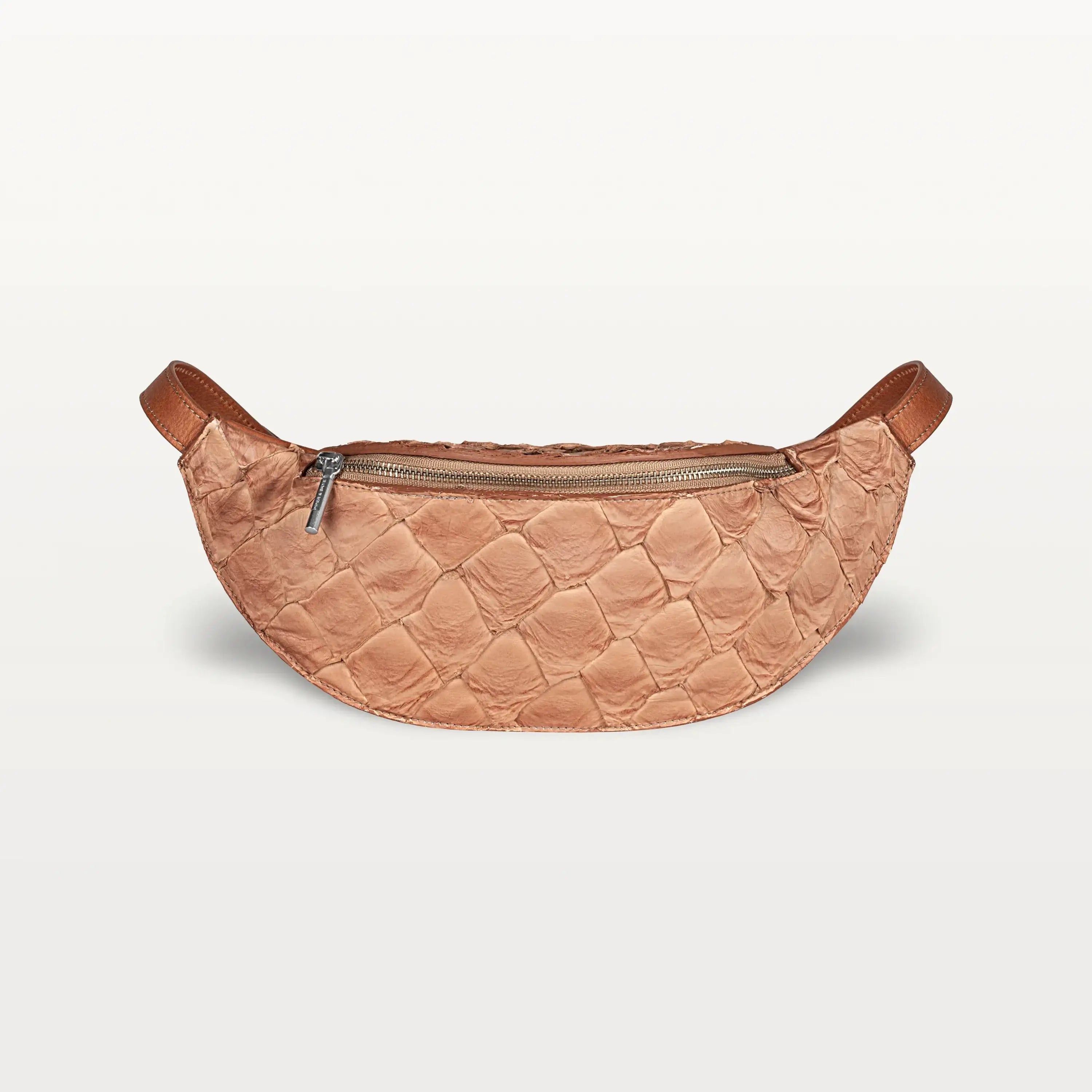 Front view of the Mac Pack belt bag crossbody in cognac Pirarucu fish leather with a silver zipper and curved body shape.