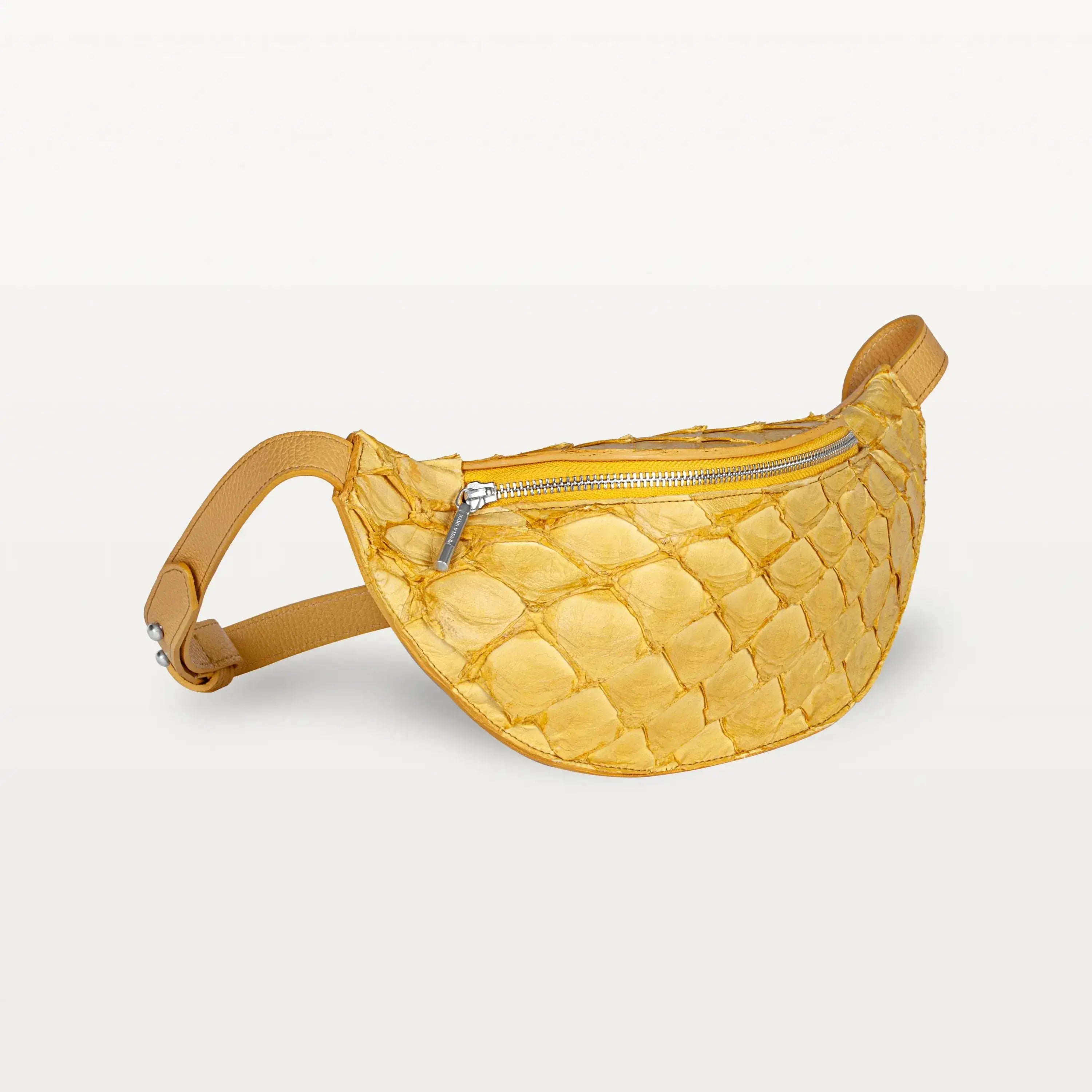 Side view of the Mac Pack belt bag pouch in honey yellow pirarucu fish leather showing the tapered body and adjustable leather belt strap.