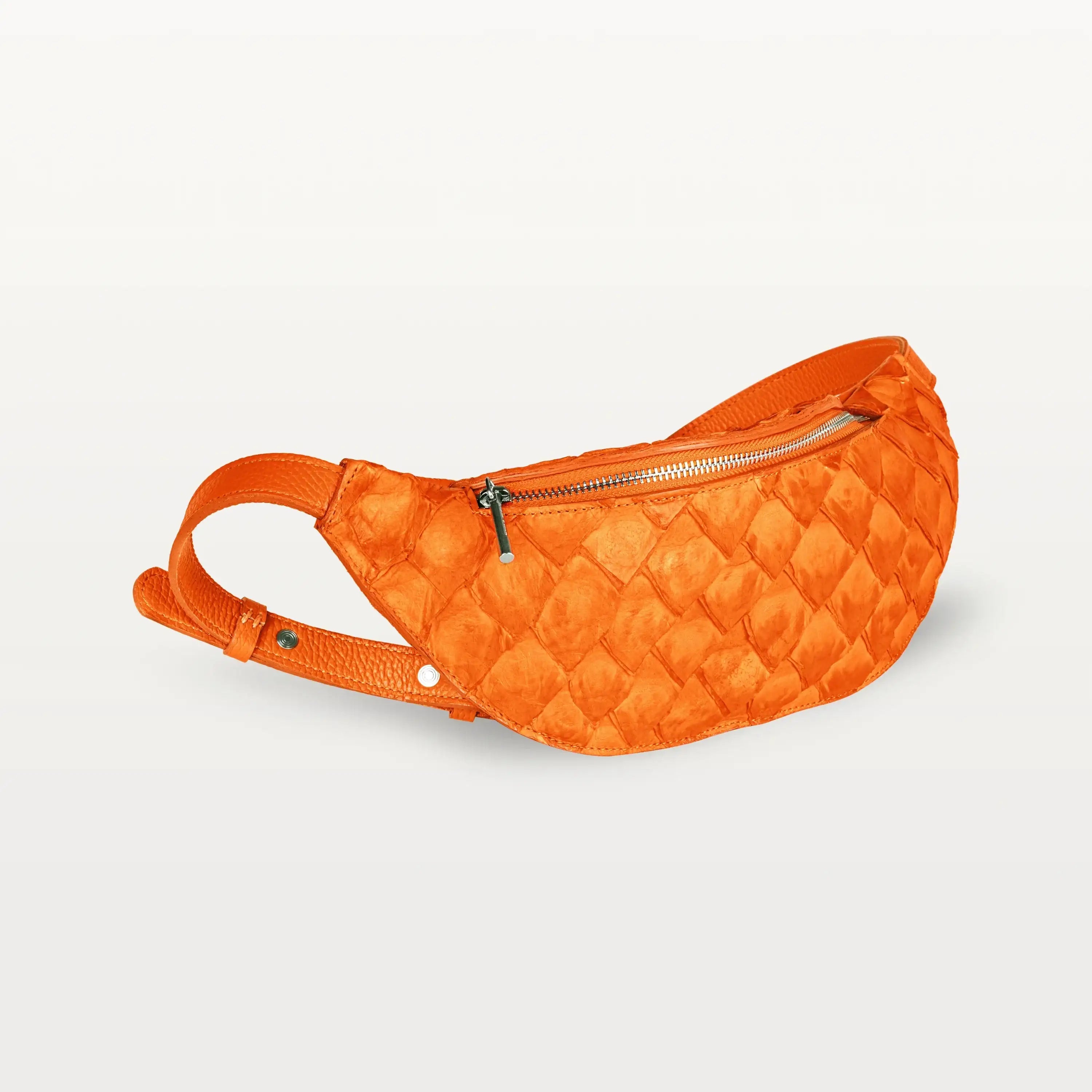 Side view of the Mac Pack belt bag in orange pirarucu fish leather showing the tapered body and adjustable leather belt strap.