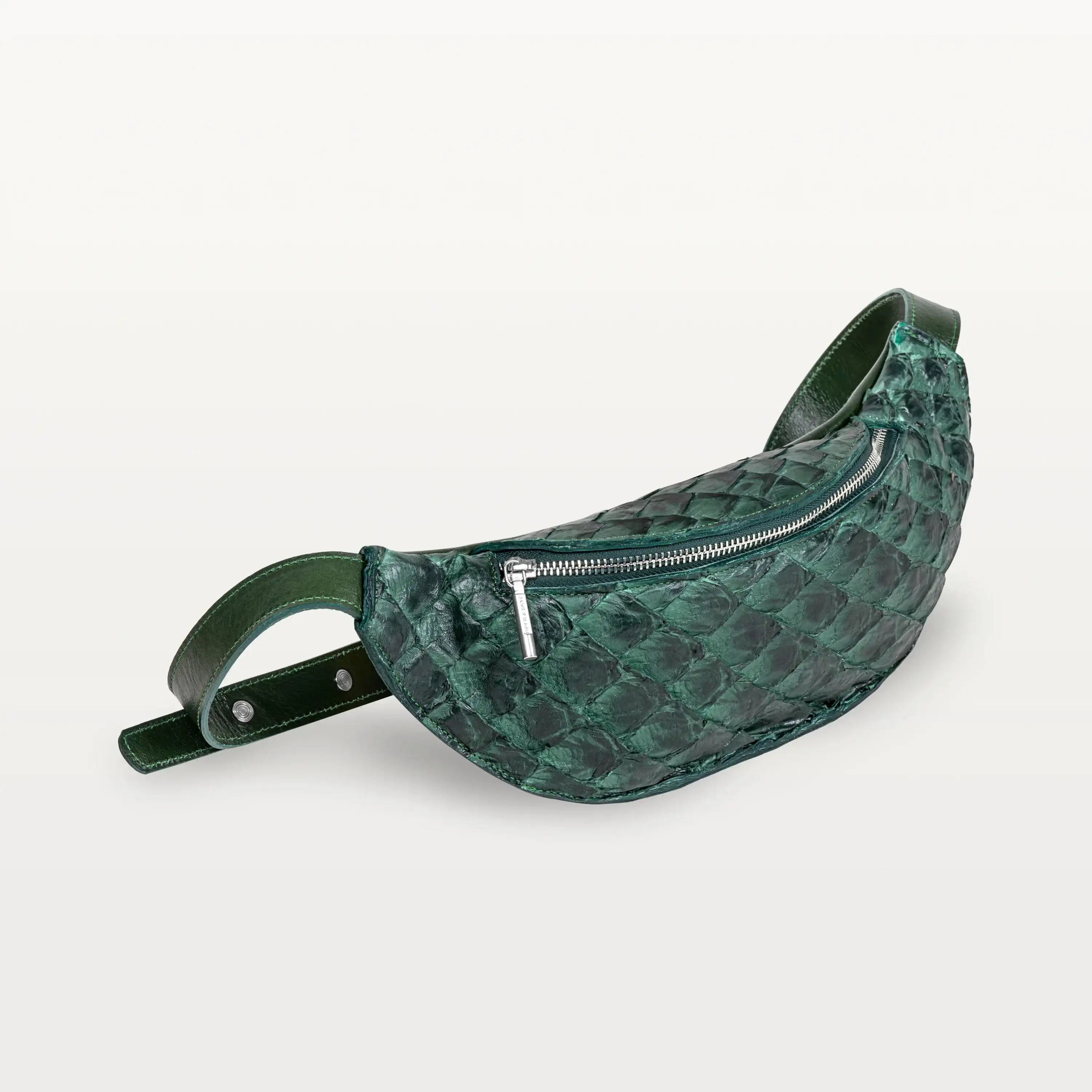 Side view of the Mac Pack belt bag in verdant green pirarucu fish leather showing the tapered body and adjustable leather belt strap.