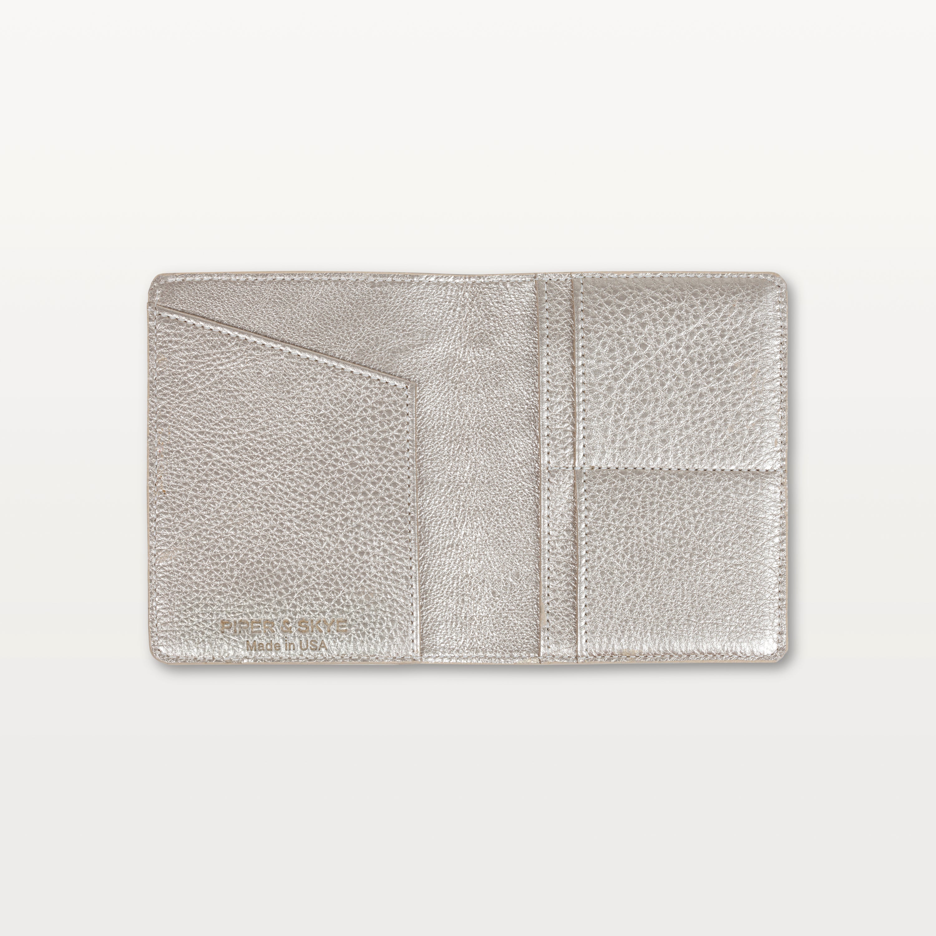 Open view of the metallic gold alligator leather passport holder showing the leather interior and slip pockets.