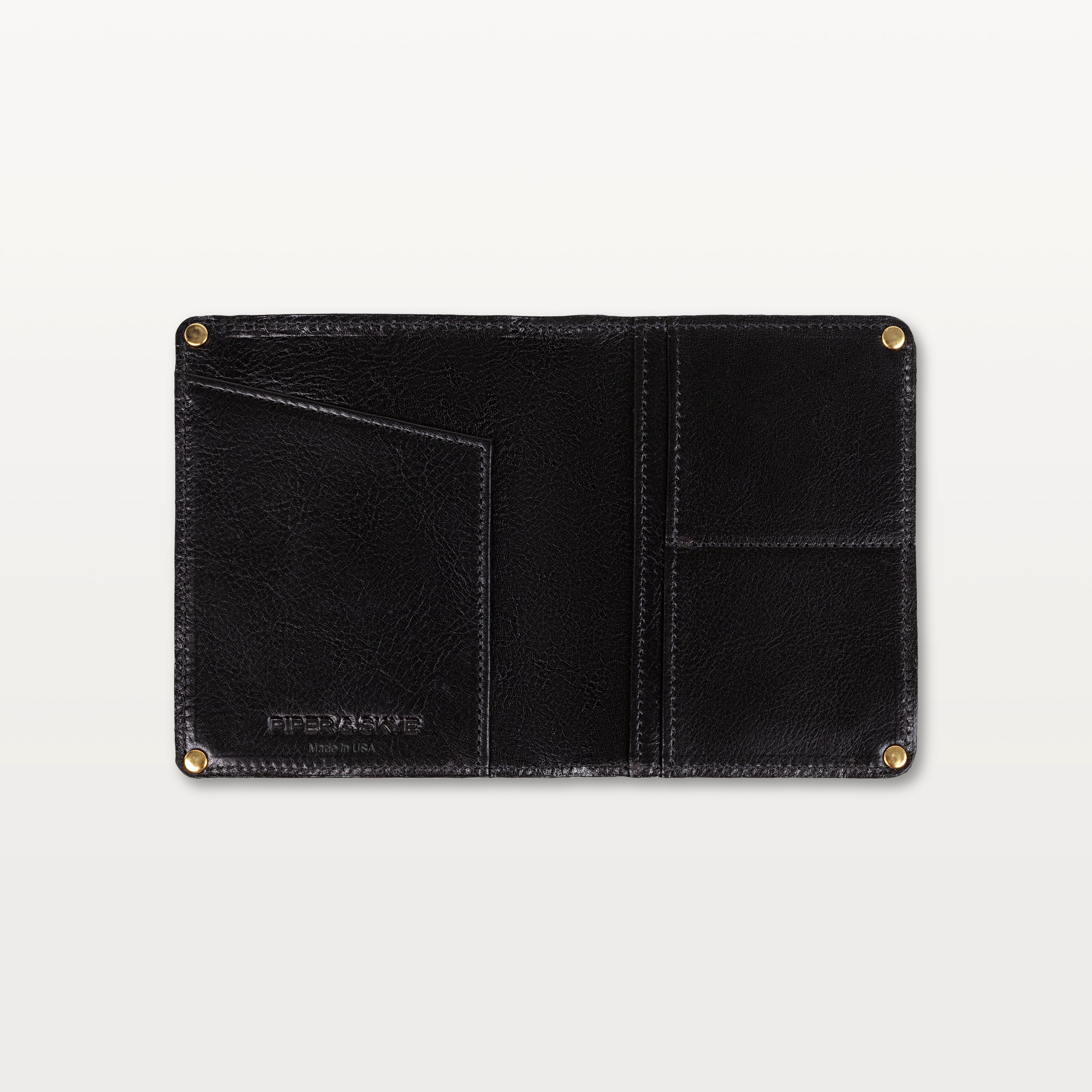 Open view of the black alligator leather passport holder showing the leather interior, gold rivets, and slip pockets.