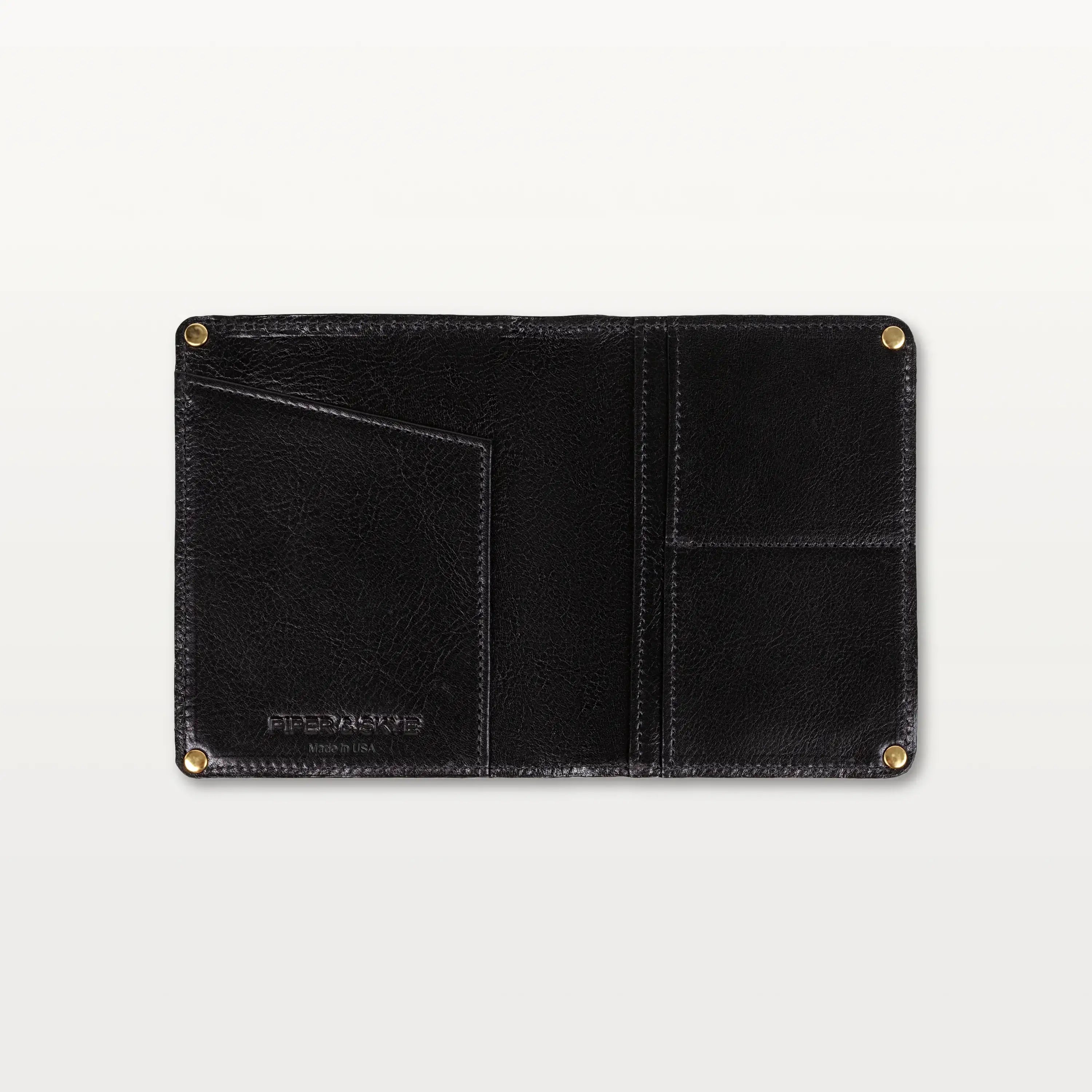 Open view of the black alligator leather passport holder showing the leather interior, gold rivets, and slip pockets.