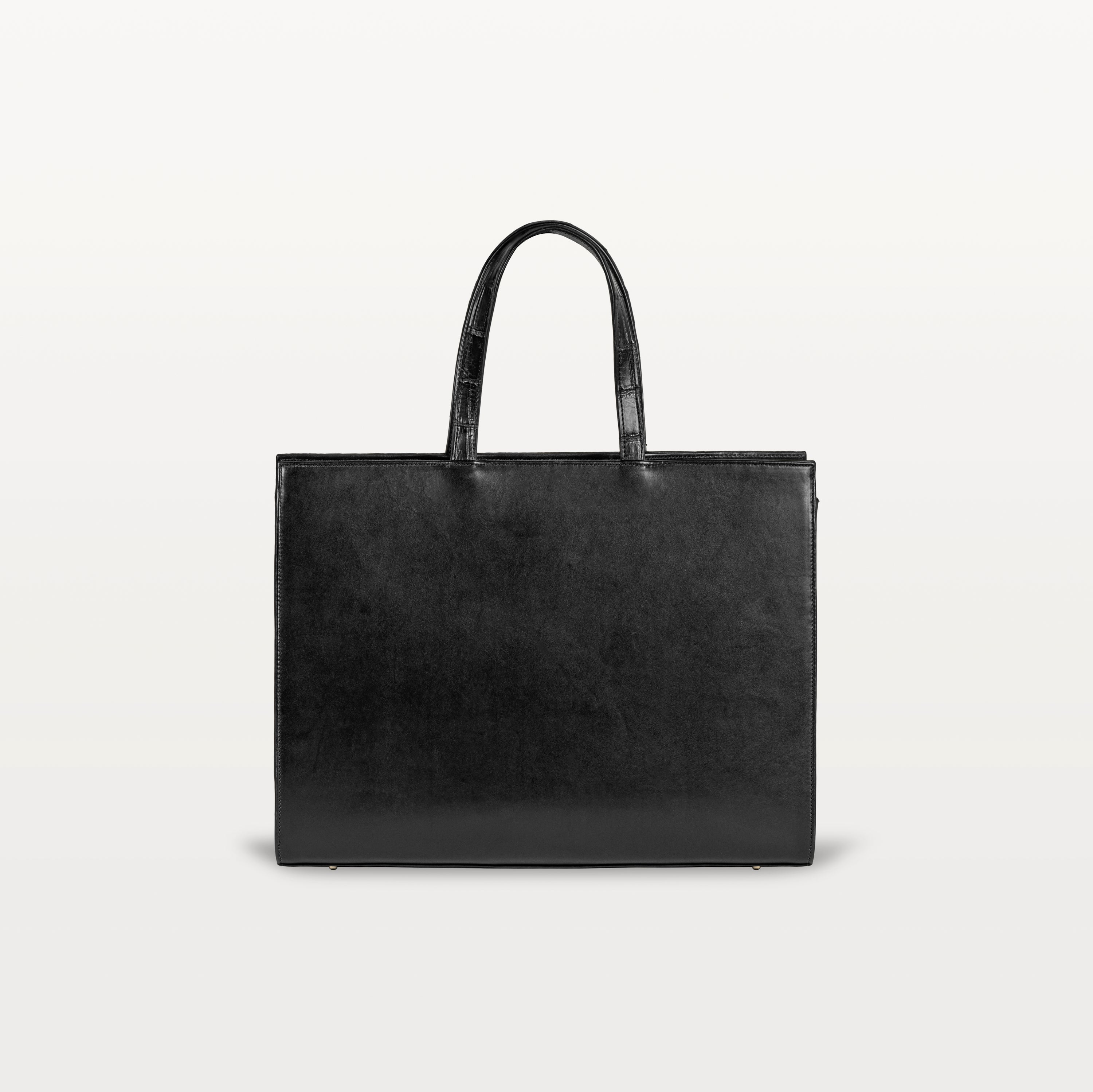 The black bovine leather rear of the Braemar tote bag with the top handles up.