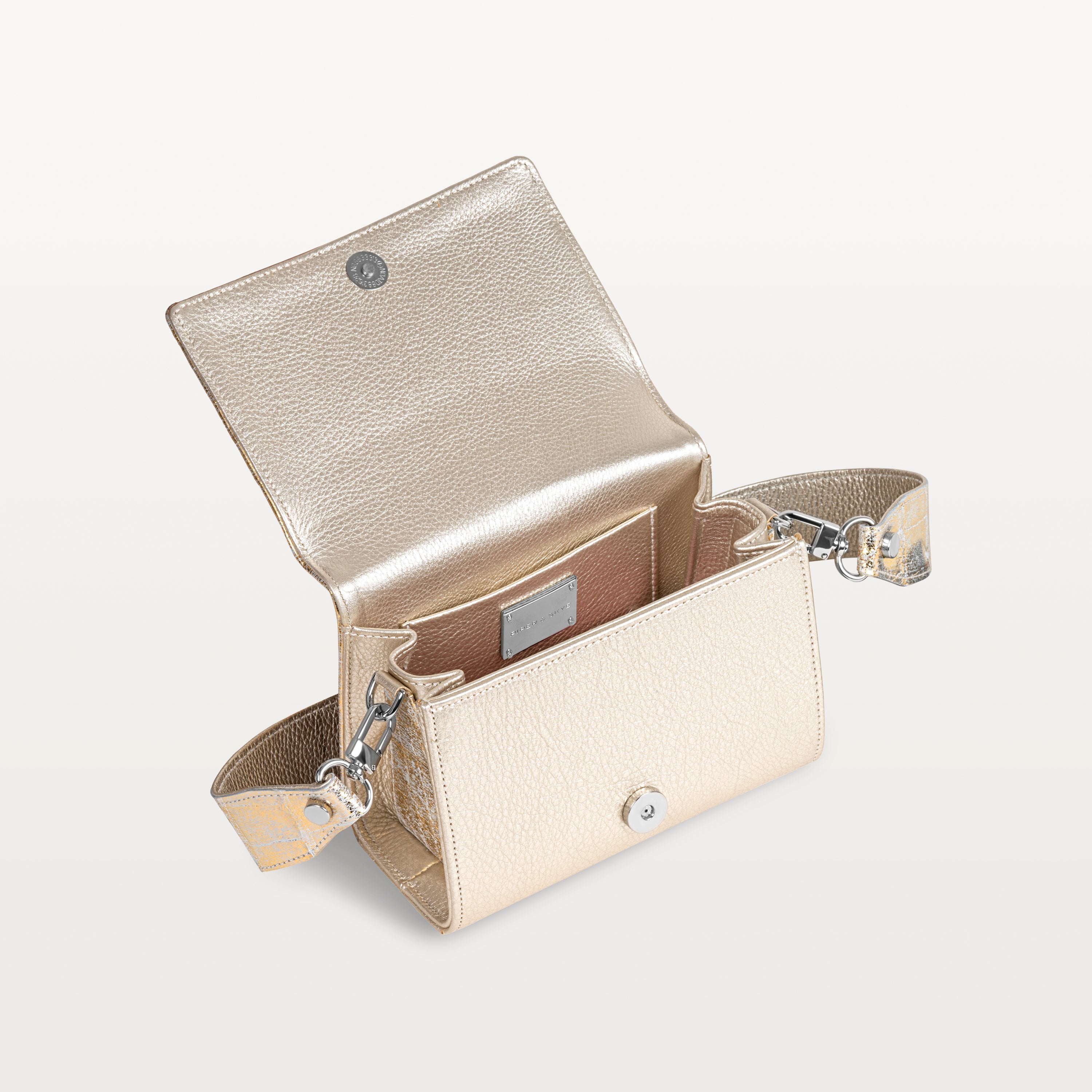 Interior view of metallic gold Lola crossbody bag in alligator showing the detachable crossbody strap, inner pocket and magnetic snap closure.