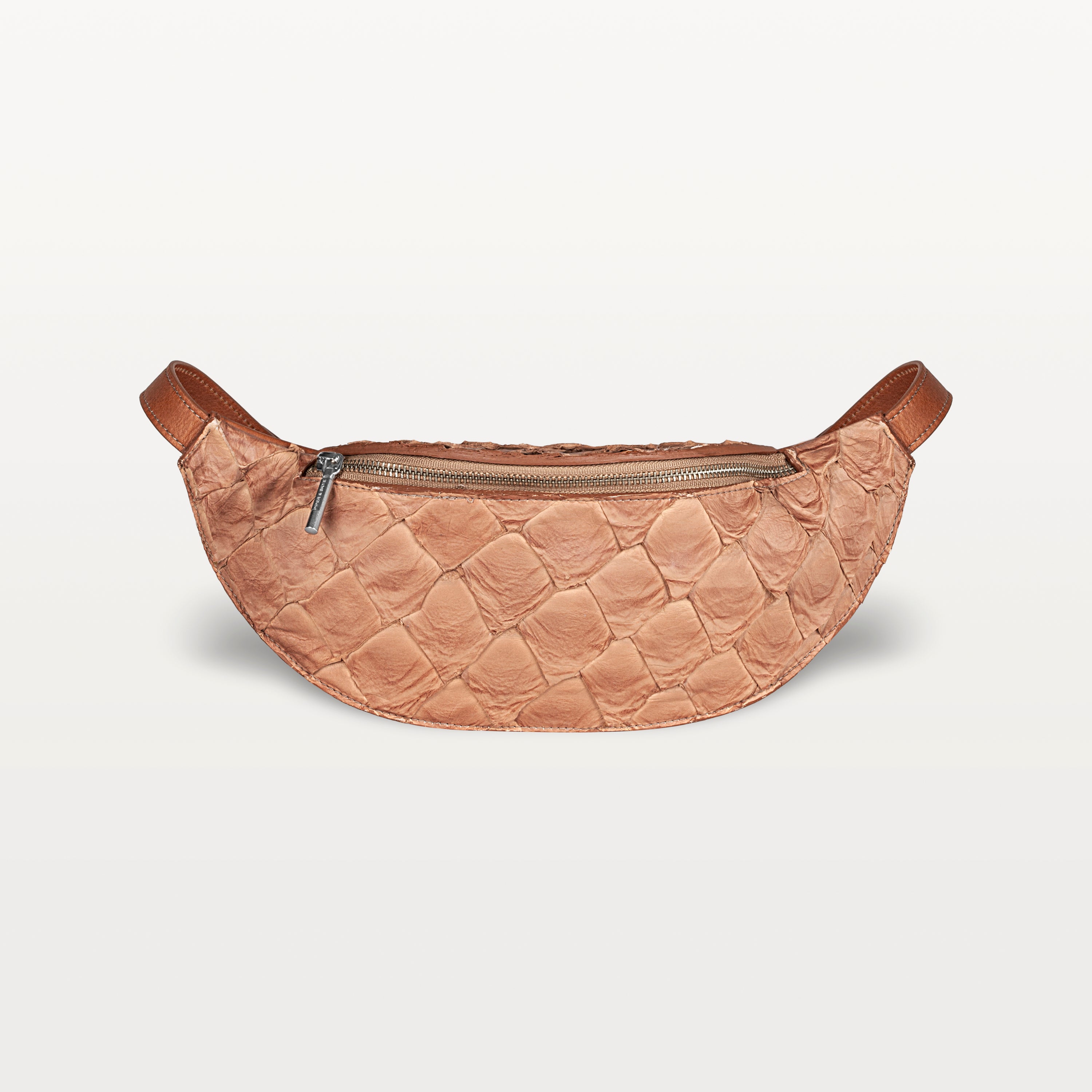 Front view of the Mac Pack belt bag in cognac Pirarucu fish leather with a silver zipper and curved body shape.