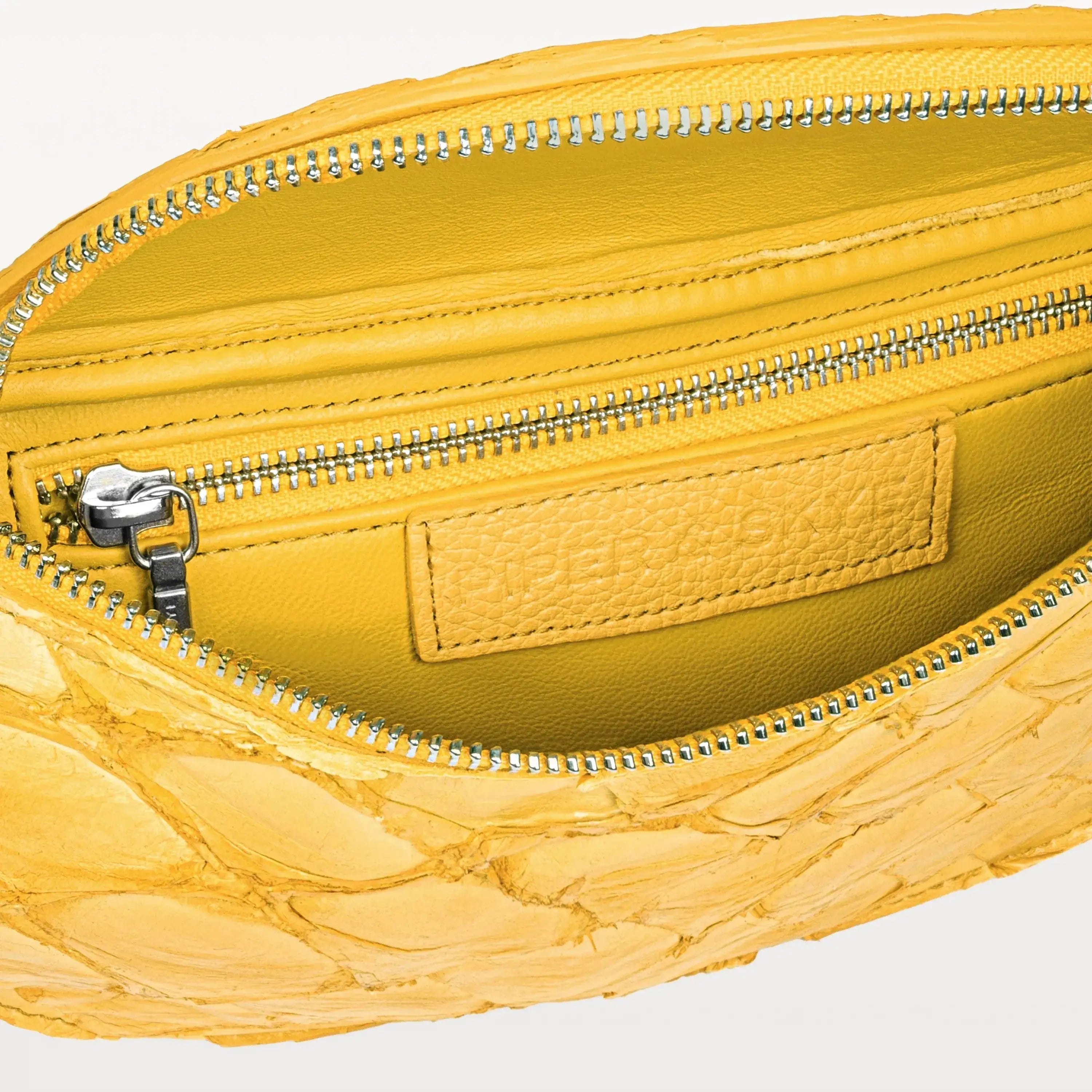 Yellow interior of the honey yellow pirarucu Mac Pack belt bag showing the inner zippered pocket. 
