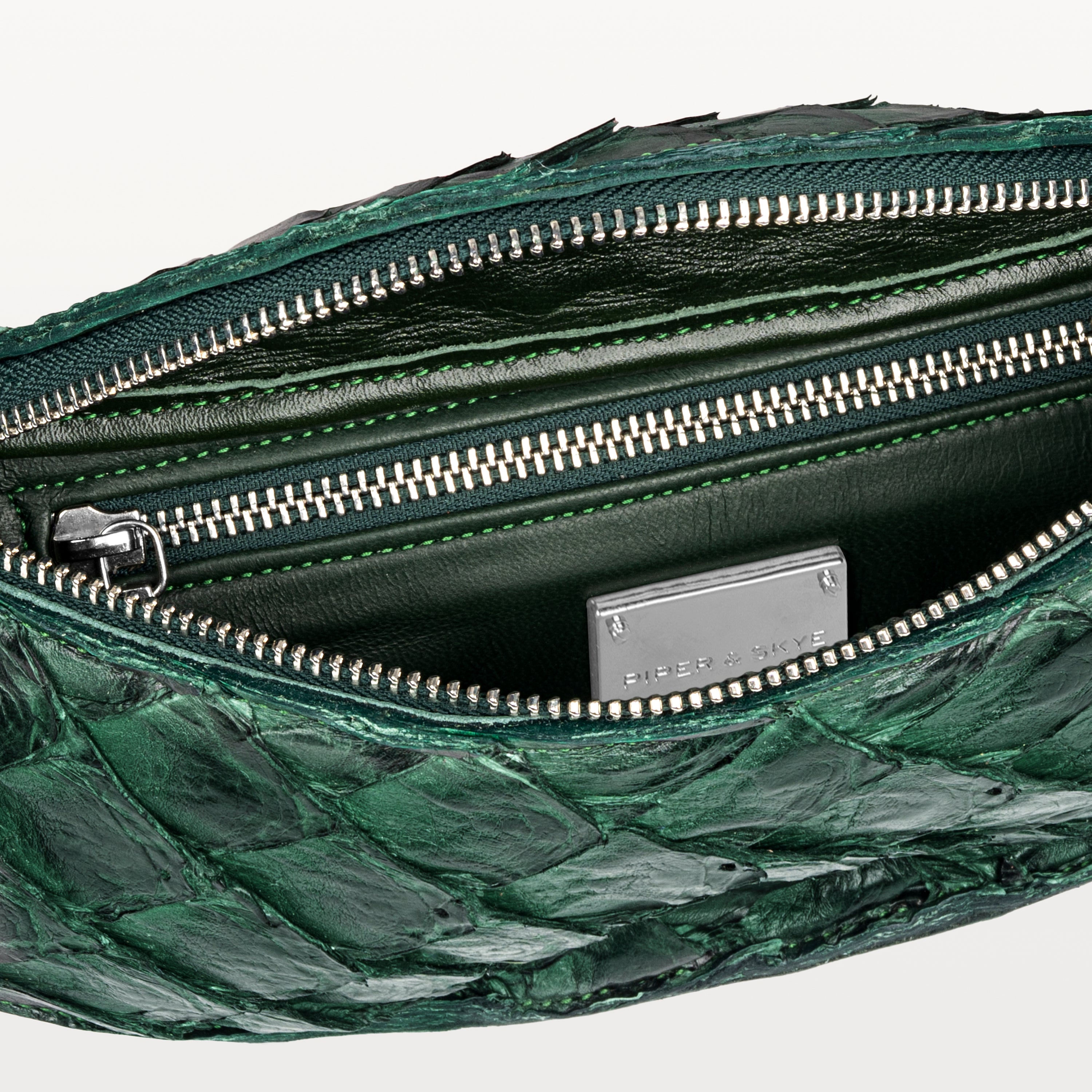 Green interior of the verdant green pirarucu Mac Pack belt bag showing the inner zippered pocket. 