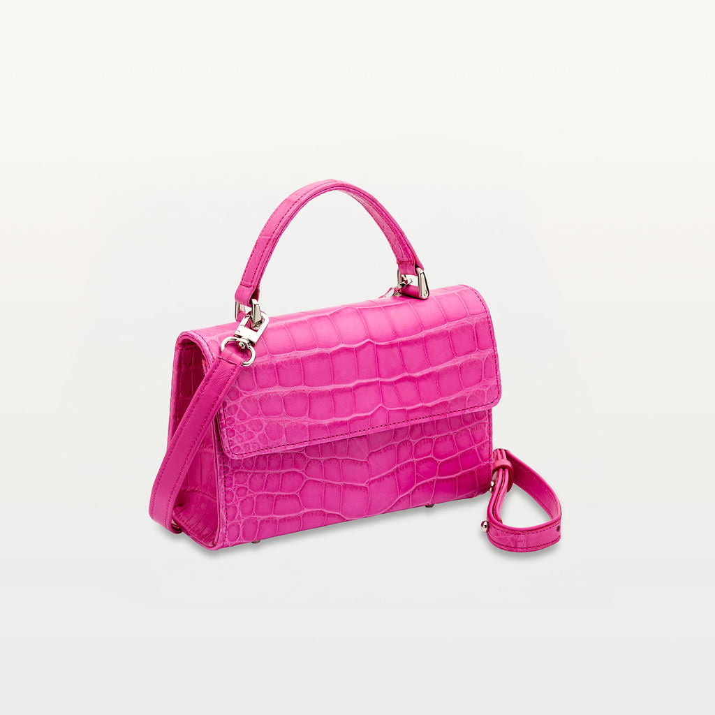 side view of sustainable leather soho top handle handbag from Piper & Skye in pink alligator.