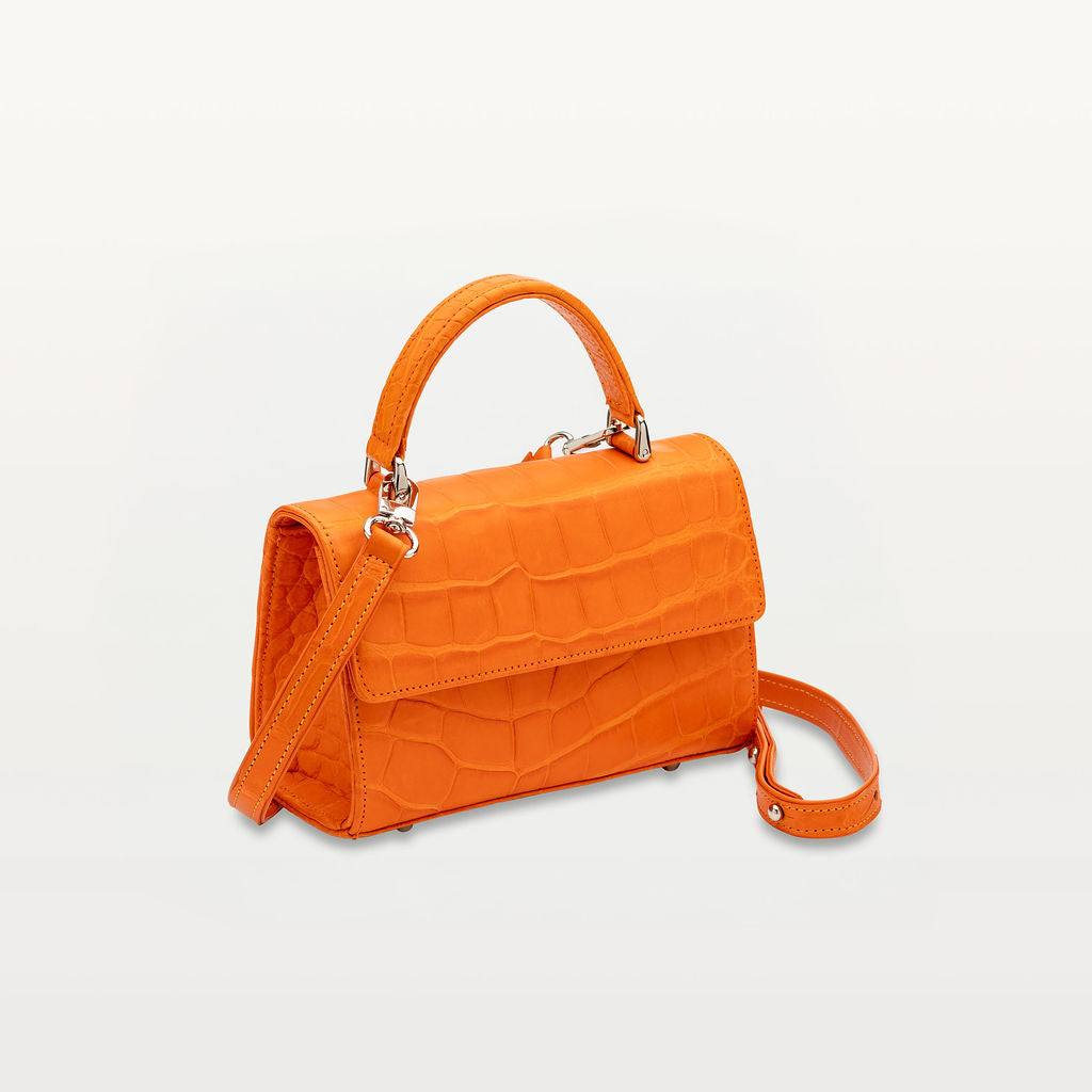 Side view of sustainable luxury crossbody handbag from Piper & Skye in Clementine Orange.