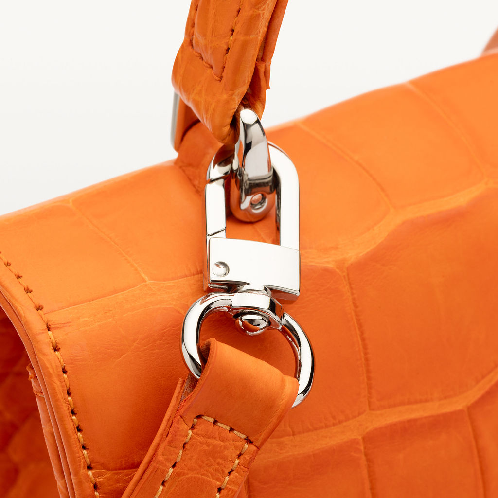Close up of silver hardware on Piper & Skye's sustainable luxury Soho Top Handle handbag.