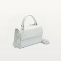 Side view of Piper & Skye's sustainable leather Soho Top Handle crossbody handbag in Moonstone White.